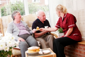 elderly couple and care worker